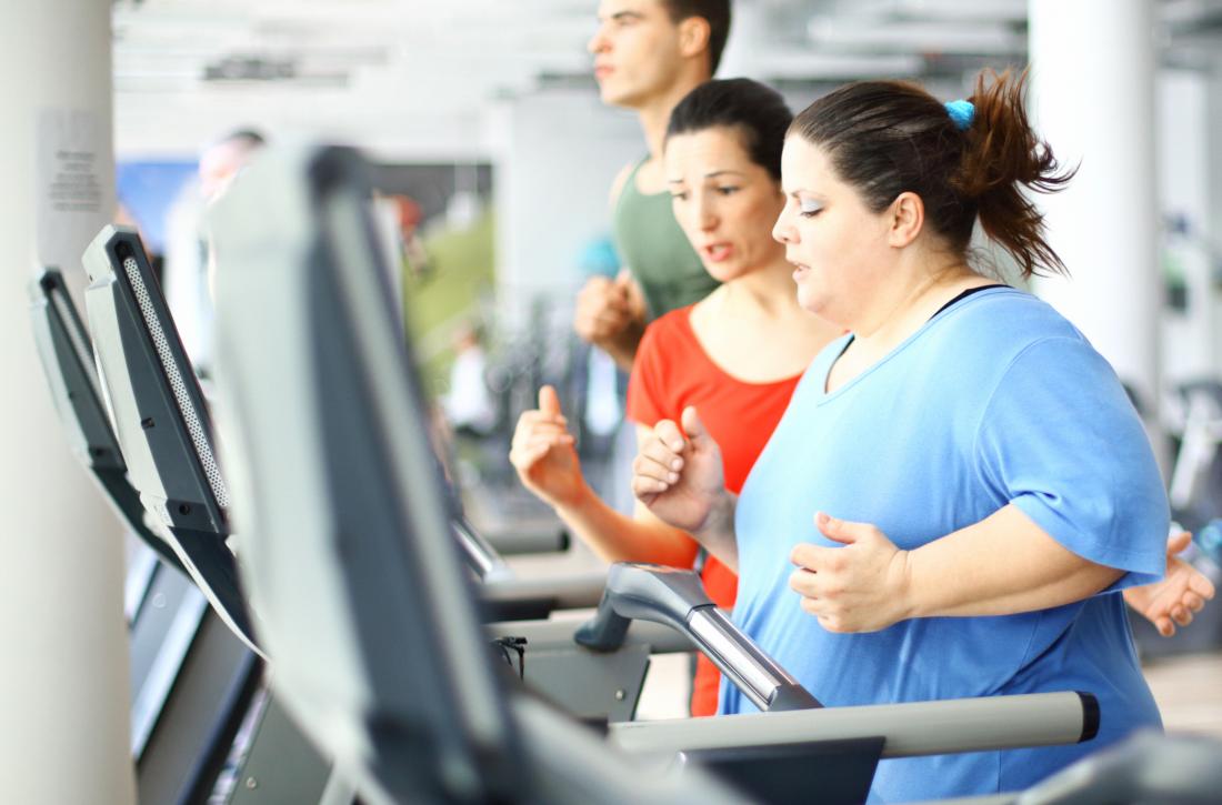 obese woman running on treadmill